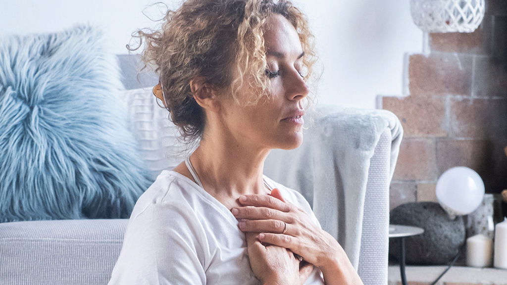 woman-meditating-hands-on-heart