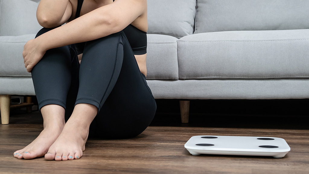 woman-sitting-beside-scale