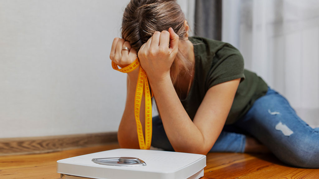 woman discouraged by weight gain